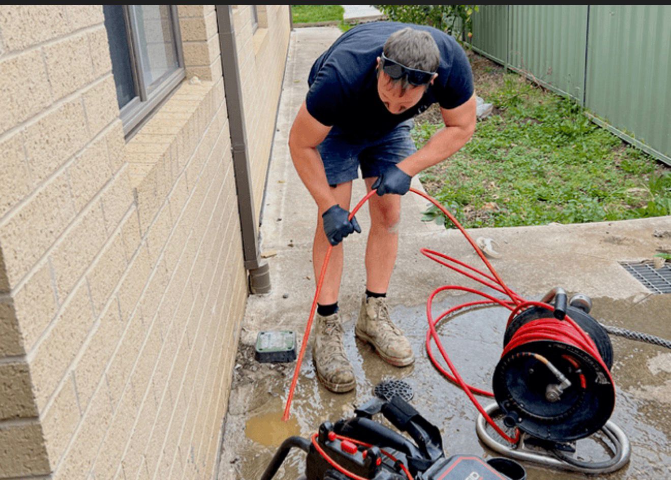 Plumber working on drain