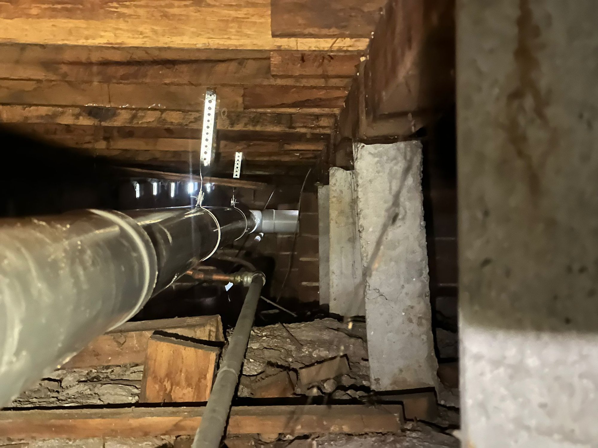 PVC drainage pipe run through timber floor cavity